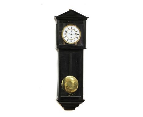 An ebonised regular wall clock,late 19th century, of architectural design, with a circular enamelled dial, enclosing a single