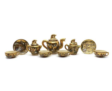 A collection of Japanese Satsuma ware tea service, early 20th century, comprising a teapot, a sugar bowl, two milk jugs, eigh