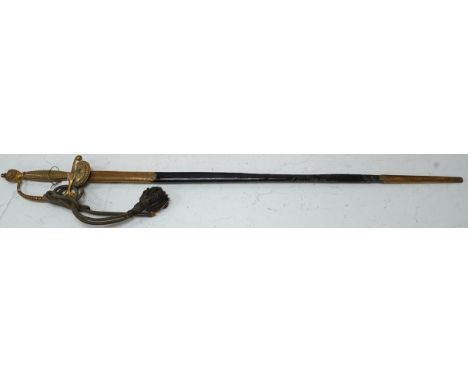 A late Victorian court sword gilt brass hilt with crown on guard, beaded edges, bullion dress knots, in its leather scabbard,