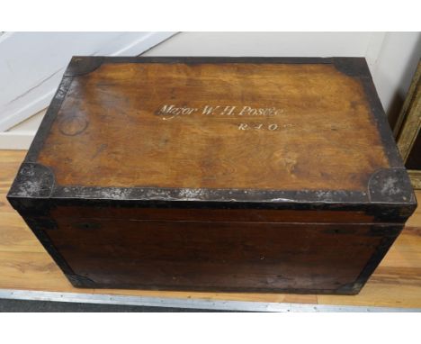 A pine military trunk with steel banding to all edges and corners, and original tin lining, owner’s name painted to the lid; 