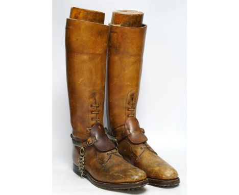 A pair of military First World War boots in tan leather, hobnail soles, two-part wooden shoe trees, and spurs. Condition - fa