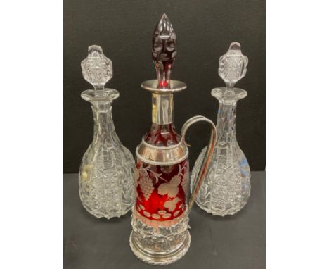 A ruby flashed clear glass claret jug decanter, silver plated embossed floral mounts and handle;  a pair of Victorian cut gla