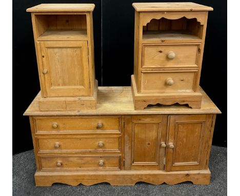 A Pine low side cabinet, over-sailing rectangular top, above three long drawers, and a pair of cupboard doorsenclosing shelvi
