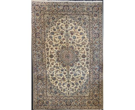 A Central Persian Kashan garden Carpet, all over decorated with floral sprays in red, blue, green on a cream field, 295cm x 2