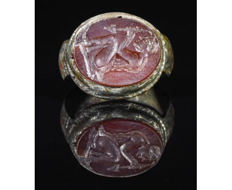 Ca.250 AD. Interesting Sassanian silver ring with carnelian intaglio depicting a kneeling figure, that resembles a kneeling G