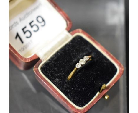 A diamond trilogy ring, round brilliant cut, total estimated diamond weight approx 0.12ct, platinum crown, 18ct gold shank, 1