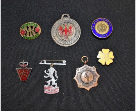 Badges - a First World War enamel and brass badge, On War Service 1914; a Primrose League badge; a Women's Institure enamel b