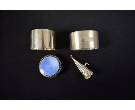 Silver - a circular guilloche enamel topped pill box, Birmingham 1925; two silver napkin rings; etc. (4)