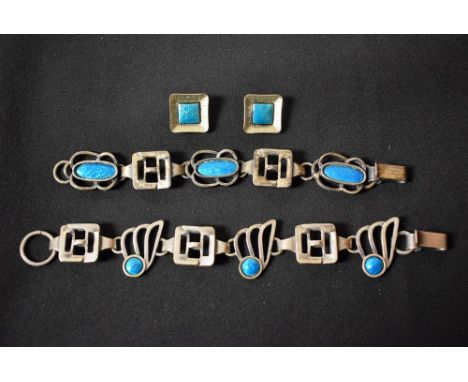 A craftsman made silver plate and peacock blue enamel bracelet; another similar; a conforming pair of clip earrings (3) 