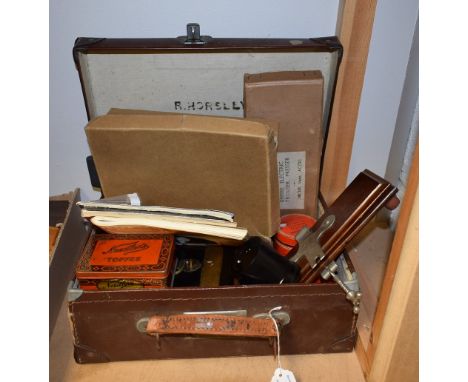 A brown leather case; a metal cash box; a gentleman's vanity case; an ebonised hand mirror, hair tidy and pin tray; a slide r