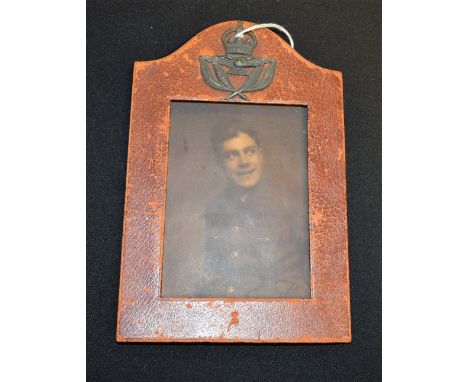 Militaria - RAF - an early 20th century red morocco arched rectangular easel photograph frame, crested with an RAF Warrant Of