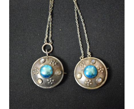 An Arts and Crafts cloak pin, target shape, turquoise enamel rounded, moonstone set 