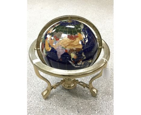 A globe, set with semi precious stones 