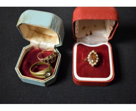 A 9ct gold seed pearl ring; another 9ct gold ring; a metal ring (3) 