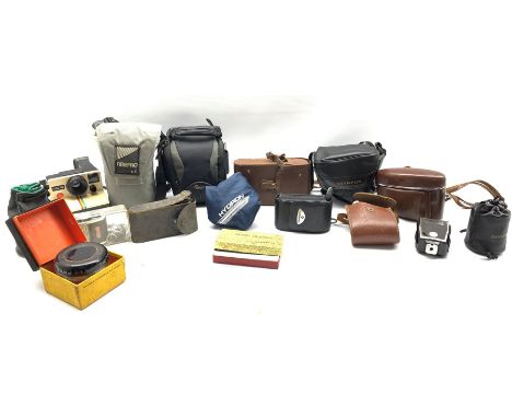 Assorted photographic items including Lumix FZ18 digital camera, Polaroid land camera with instruction booklet and film, Olym
