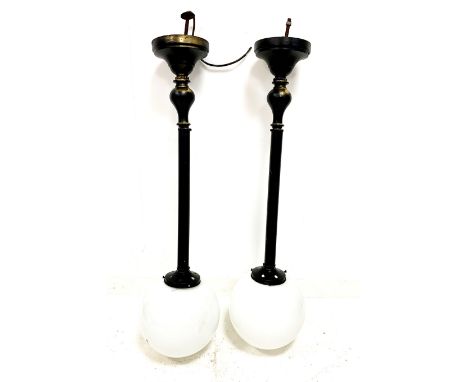 Pair of black and gilt metal pendant light fittings with opaque glass shades