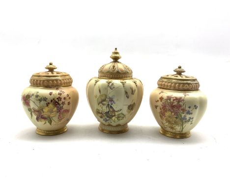 Pair of Royal Worcester pot pourris and covers decorated with floral sprays on a blush ivory ground H14cm and a single Worces