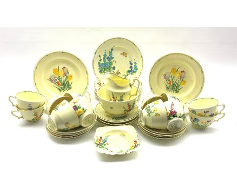 Art Deco Crown Staffordshire 'Pan' Design tea service for twelve, printed and painted in bright enamels with assorted spring 