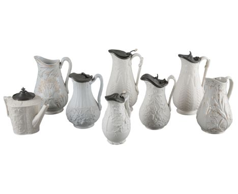 A VICTORIAN RELIEF MOULDED TEAPOT BY BROWNFIELD & SONmarked to the base, in the 'Mistletoe pattern', with a pewter lid, 17cm 