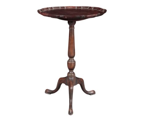 A GEORGE III MAHOGANY TRIPOD TABLE the tilt top with a pie crust edge, on a baluster turned stem to slender cabriole legs, 71