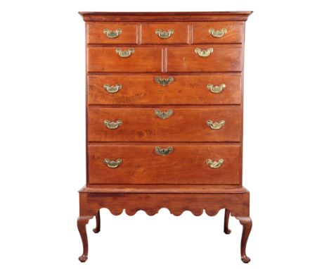 A CHIPPENDALE STYLE WALNUT CHEST ON STAND possibly American, the upper section with five short drawers over three long gradua