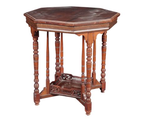 AN EDWARDIAN WALNUT OCCASIONAL TABLE IN THE MANNER OF JAMES SHOOLBRED the octagonal top on ring-turned supports joined by a s