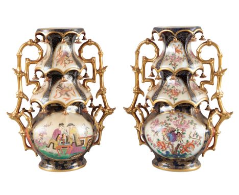 A PAIR OF CONTINENTAL PORCELAIN 'PAGODA' VASES19th century, the three tiered design with gilded ceramic 'bells' and branch-li