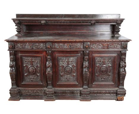 A VICTORIAN OAK BUFFET the top with a raised gallery with a single shelf, the base with three frieze drawers over three cupbo