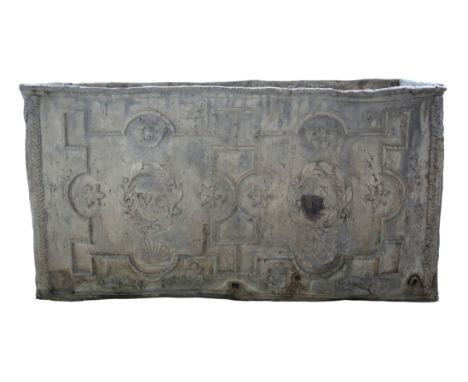 A GEORGE I LEAD CISTERNdated 1716, the front bearing the initials 'WC' set within laurel wreaths, cast with winged cherub, sh