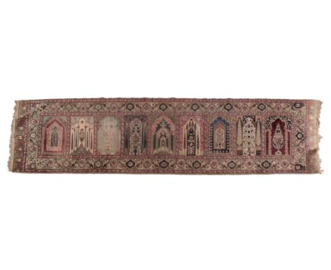 AN ANTIQUE TURKISH SILK 'MOSQUE' PRAYER RUGwoven in colours with nine arches for multiple worshippers, each arch of individua