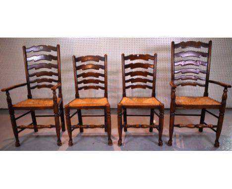 A SET OF FOUR MODERN OAK LADDER BACK DINING CHAIRS WITH RUSH SEATS (4)Including two carvers