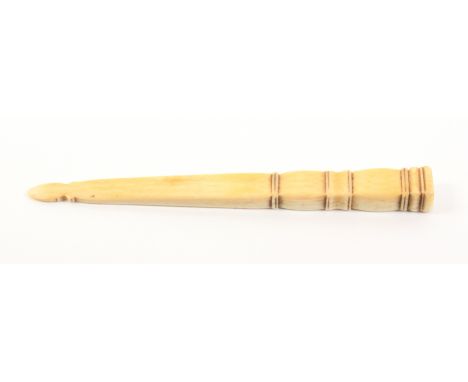 An early 19th Century ivory knitting stick, probably French, of rectangular section and tapering form, 15cm