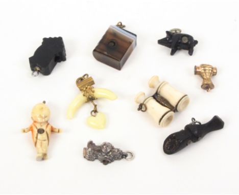 Nine charms and novelties all with Stanhopes comprising an agate book, (six view _ Memory of Southport), 1.7cm, a bog oak har