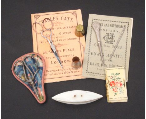 A mixed lot _ sewing comprising a mother of pearl shuttle, 8cm a painted and inscribed bone needlebook, a Georgian silver ope