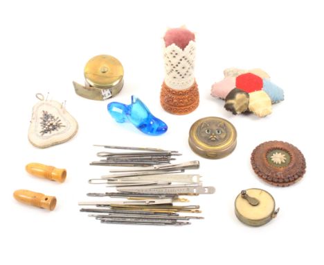 A mixed lot _ sewing _ comprising a bone and coquilla standing pincushion, 8cm, a patchwork pincushion, another of pear shape
