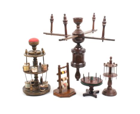 Four reel stands and a wool winder comprising a 19th century turned oak example, 22cm high, another in mahogany of ladder for