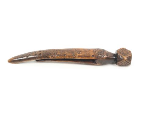 A carved fruitwood knitting stick of clothes peg form, curved, initialled and dated ñS.A. 1787î to the reverse, the front fac