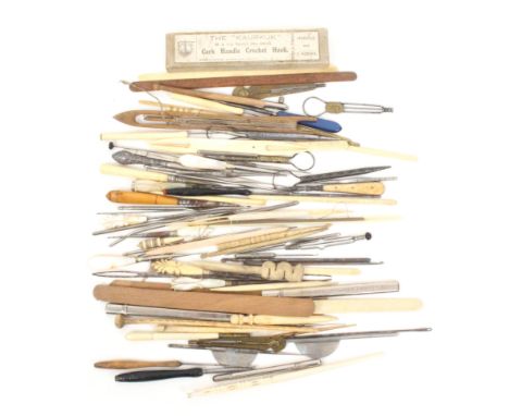 A comprehensive selection of crochet hooks and stilettos including three brass patent crochet hooks together with bone nettin