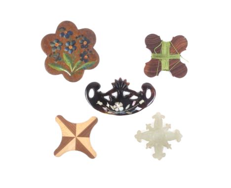 A collection of silk winders comprising a pierced tortoiseshell example of crescent form with mother of pearl and metal inlay