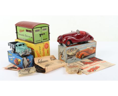 Three Original Boxed Schuco models, Akustico 2002, maroon tinplate body, working clockwork mechanism,with key, instruction le