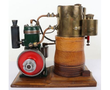 An interesting Stuart Turner vertical petrol engine with raised water tank, mounted cast cylinder with spark plug and exhaust