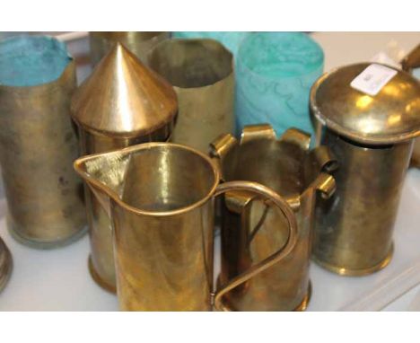 GROUP OF BRASS SHELL CASE VASES
a trench art money bank and two jugs 