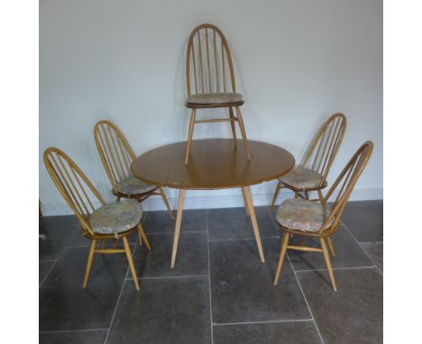 An Ercol Golden Dawn elm drop leaf dining table with 5 stick back chairs - table height 73cm x diameter 112cm - chairs 95cm t