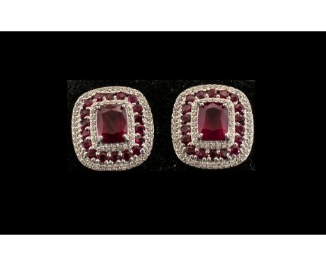 Ruby Pair of Large Stud Earrings, each earring having an octagon cushion cut solitaire ruby framed by a line of white, natura