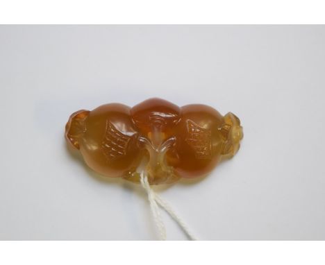 A Chinese jade carving of fruit, 6cm wide.