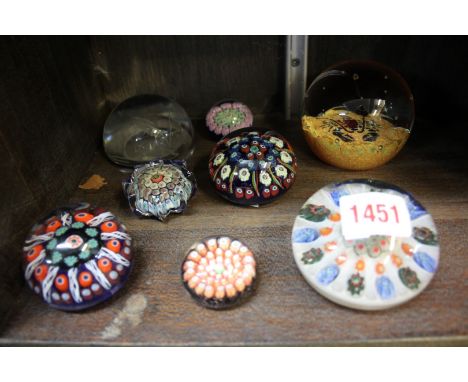 A collection of eight glass paperweights, to include examples by Caithness, Perthshire and Murano. 