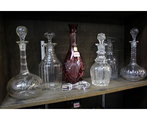 Six various decanters and stoppers, to include, a ruby stained example.