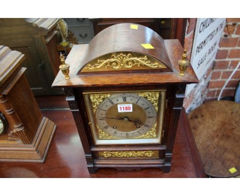 A circa 1900 century oak and brass mounted mantel clock, striking on two gongs, 37.5cm high.