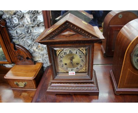 A late 19th century carved walnut mantel clock, with pointed arched top, 38cm high.
