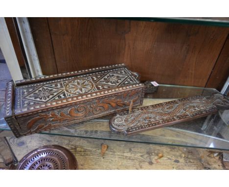 A 19th century carved oak candle box, possibly Welsh, 55cm long; together with a similar cribbage board, 48cm long. 